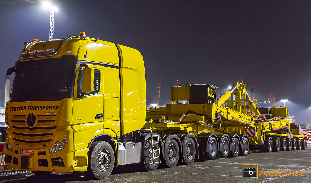 some heavy transport trucks in the night